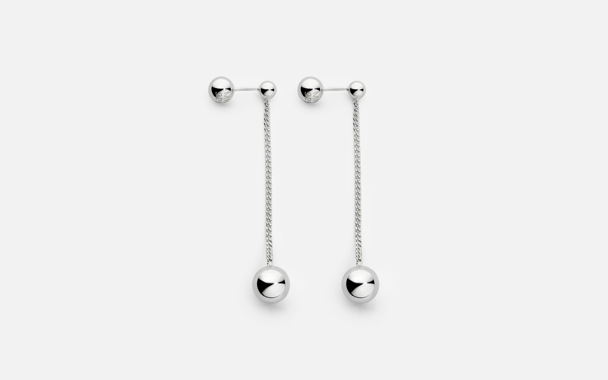 Pair of silver earrings with dangling chains on a white background