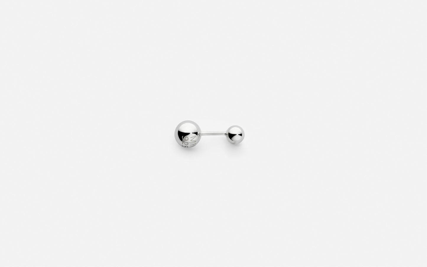 Silver earring on a white background